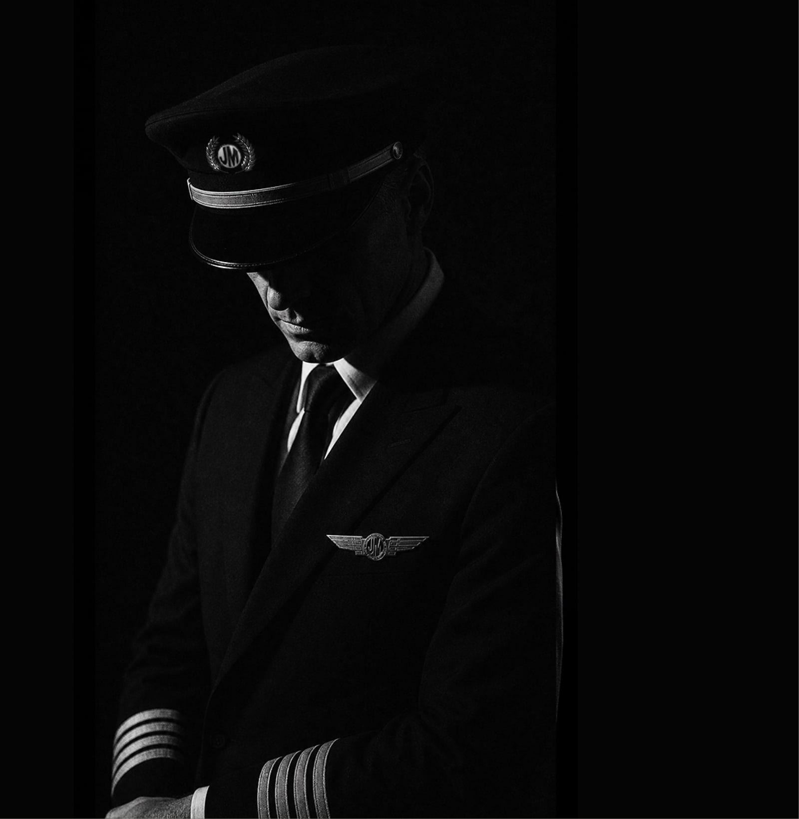 Jonny Masters in uniform, cap low, winged JM crest on the lapel